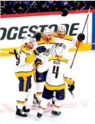  ?? THE ASSOCIATED PRESS ?? Predators defenseman Mattias Ekholm (14) is congratula­ted by teammates Colton Sissons (10), Ryan Ellis (4) and Austin Watson after scoring a goal against the Colorado Avalanche on Sunday during Game 6 of a first-round playoff series in Denver. The...
