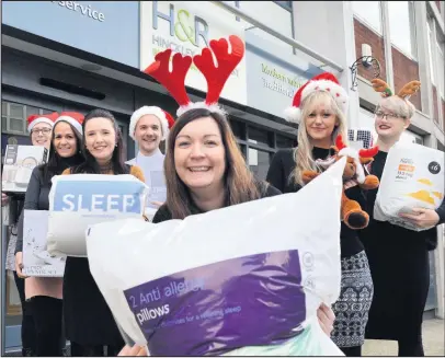  ??  ?? Staff members from Hinckley and Rugby Building Society have donated everyday essentials and items to a Leicesters­hire charity’s Collect for Christmas appeal which helps to provide care packages for the homeless.