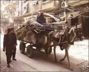  ??  ?? People with their belongings in the besieged town of Douma, eastern Ghouta