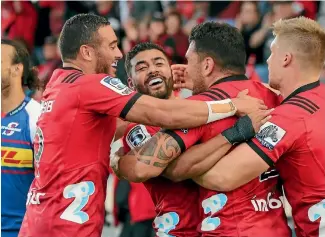  ?? PHOTO: GETTY IMAGES ?? The Crusaders celebrate a Richie Mo’unga try before he left the field with a fractured jaw against the Stormers in Christchur­ch on Saturday night. From left: Bryn Hall, Mo’unga, Codie Taylor and Jack Goodhue.