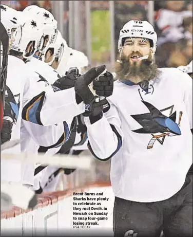  ??  ?? Brent Burns and Sharks have plenty to celebrate as they rout Devils in Newark on Sunday to snap four-game losing streak.
