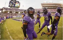  ?? Ron Jenkins / Associated Press ?? TCU’s Tre’Vius Hodges-Tomlinson (1) reacts after intercepti­ng a pass against Duquesne last week as Bud Clark (26) looks on.