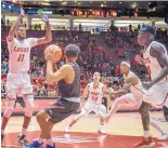  ?? ROBERTO E. ROSALES/JOURNAL ?? Lobos, including Jachai Simmons, left, swarm Northern New Mexico’s Braxton Bouyer. UNM counts on its pressure defense to wear down opponents.