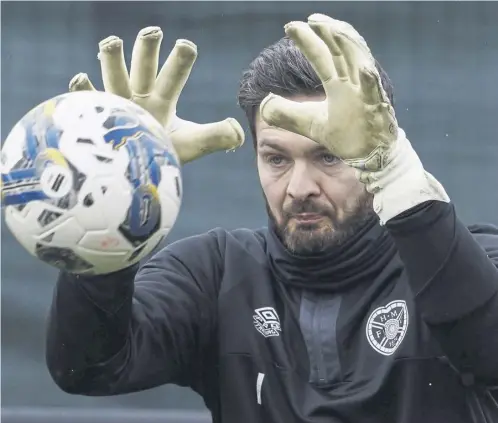  ?? PICTURE: MARK SCATES/SNS ?? Craig Gordon keeps his eyes on the ball at the Oriam yesterday and, below, looking fresh faced at the beginning of his Hearts career almost 25 years ago