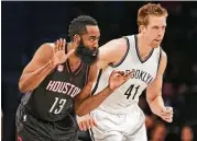  ?? Seth Wenig / Associated Press ?? Rockets guard James Harden (13) makes sure the Nets’ Justin Hamilton knows his shot just went in.