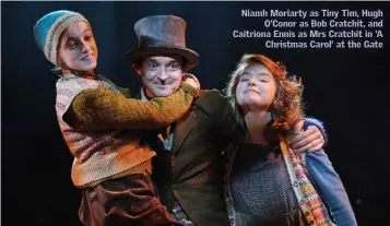  ??  ?? Niamh Moriarty as Tiny Tim, Hugh O’Conor as Bob Cratchit, and Caitriona Ennis as Mrs Cratchit in ‘A Christmas Carol’ at the Gate