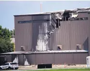  ?? SHABAN ATHUMAN/THE DALLAS MORNING NEWS ?? Damage is seen to a hangar after a twin-engine plane crashed into the building at Addison Airport in Addison, Texas, on Sunday.