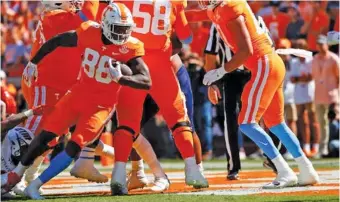  ?? TENNESSEE ATHLETICS PHOTO ?? Tennessee sixth-year senior tight end Princeton Fant works his way into the end zone for one of his two rushing scores during Saturday’s 65-24 defeat of UT Martin. Fant also threw a 66-yard touchdown pass.