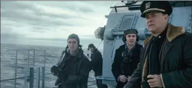  ??  ?? Captain Ernest Krause (Tom Hanks) and members of his crew watch for German U-boats in “Greyhound,” which is streaming on Apple
TV +.