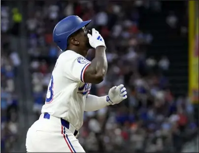  ?? TONY GUTIERREZ — THE ASSOCIATED PRESS ?? The Texas Rangers’ Adolis García celebrates his three-run home run as he jogs home in the second inning against the Houston Astros on Friday in Arlington, Texas.