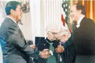  ?? EUSTIS HIGH SCHOOL/COURTESY ?? The “hall of fame” exhibit at Eustis High School shows John Robert Schrieffer shaking hands with former President Ronald Reagan.