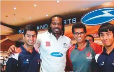  ?? Gulf News Archive ?? West Indies legendary batsman Chris Gayle with coach Gopal Jasapara (third from left) and G Force Academy’s players Shorye Chopra and Kartik Shekar.