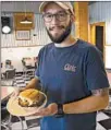  ??  ?? Chef Anthony Goldsmith serves up Shrimp on a Bun at his Kajun Twist restaurant in Galliano, La.