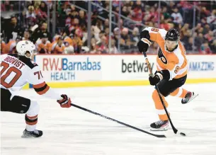  ?? ADAM HUNGER/AP ?? Philadelph­ia Flyers defenseman Ivan Provorov shoots against the New Jersey Devils during a disappoint­ing 7-0 loss Saturday night.
