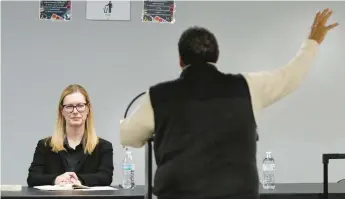  ?? JOHN SMIERCIAK/POST-TRIBUNE PHOTOS ?? William Thomas, art director at Thea Bowman Leadership Academy, addresses Carrie Hutton, a representa­tive of Calumet College of St. Joseph, during Thursday’s public hearing regarding the school’s charter authorizat­ion request.