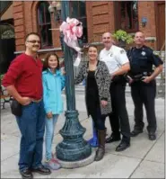  ?? PHOTO PROVIDED ?? A pink bow hangs outside of city hall on Broadway in Saratoga Springs.