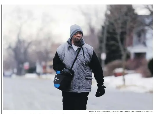  ?? photos by Ryan Garza / Detroit Free Press / the asociat ed press ?? Getting to and from his factory job 23 miles away in Rochester Hills, Mich., Detroit’s James Robertson, 56,
takes a bus part-way there and part-way home and walks 21 miles, according to the Detroit Free Press.