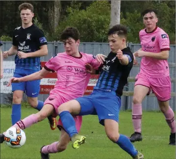  ??  ?? Ciarán Paige of Wexford F.C. battling against Callum McKelvey of Athlone Town.