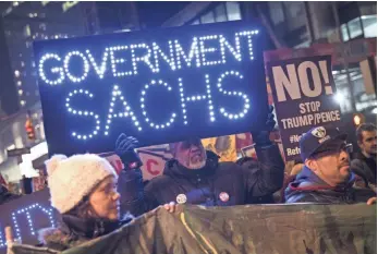  ?? DREW ANGERER, GETTY IMAGES ?? New Yorkers in favor of Dodd-Frank rules take to the streets of Lower Manhattan in February.