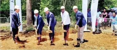  ?? FILE ?? Prime Minister Andrew Holness (centre) is assisted by Minister of Tourism Edmund Bartlett (second right) in officially breaking ground last Friday for the Rhyne Park developmen­t in Montego Bay, St James. The developmen­t will see 754 mixed units being constructe­d. Sharing in the occasion (from left) are Baoguo Chen, general manager, Henan Fifth Constructi­on Group; Senator Pearnel Charles Jr, minister without portfolio in the Ministry of Economic Growth and Job Creation and Norman Brown, chairman of the Housing Agency of Jamaica.