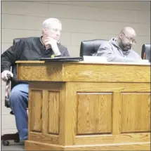  ?? Brodie Johnson • Times-Herald ?? St. Francis County Quorum Court Justices David Coleman, left, and Kendall Owens review documents during a Quorum Court meeting Tuesday at the courthouse. Justices voted to double the amount of bonuses this year for employees and elected officials.