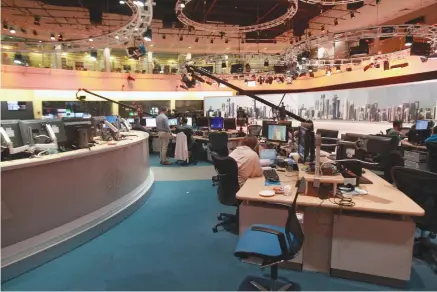  ??  ?? STAFF WORK inside the headquarte­rs of Al Jazeera Media Network, in Doha, Qatar, in June 2017.