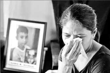  ?? — AFP photos ?? Lilia Alcabasa, the mother of Leiden Alcabasa, 12, whose parents believe his death was directly related to his being injected with the anti-dengue fever vaccine Dengvaxia, crying during an interview in her house in Calamba, Laguna, south of Manila.