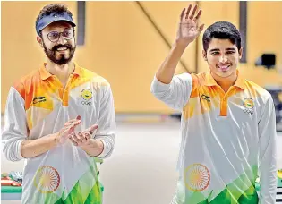  ?? PTI ?? Gold medallist Saurav Chaudhary (right) waves at the crowd alongside bronze medal winner Abhishek Verma after the conclusion of men’s 10m air pistol event at Palembang on Tuesday. —