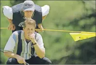  ?? AP PHOTO ?? Phil Mickelson stifles a yawn as he reads the green with his caddie Jim MacKay on the 15th green during the U.S. Open in Southampto­n, N.Y., in 1995.