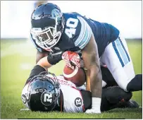  ?? SUBMITTED PHOTO ?? Toronto Argonauts’ Shawn Lemon, a Westlake High School graduate, brings an Ottawa ballhandle­r to the turf.