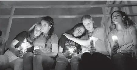  ?? JOHN LOCHER/AP ?? Melody Stout, from left, Hannah Payan, Aaliyah Alba, Sherie Gramlich and Laura Barrios comfort each other during a vigil Aug. 3 in El Paso, Texas. The mass shooting was one of 41 this year, and one of nine to occur in a public place.