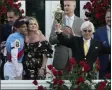  ?? JEFF ROBERSON - THE ASSOCIATED PRESS ?? Jockey John Velazquez, left, watches as trainer Bob Baffert holds up the winner’s trophy after they victory with Medina Spirit in the 147th running of the Kentucky Derby at Churchill Downs, Saturday, May 1, 2021, in Louisville, Ky.