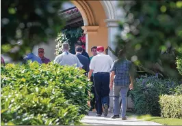  ??  ?? President Donald Trump leaves the Trump National Golf Club in Jupiter on Friday after playing golf with profession­als Tiger Woods and Dustin Johnson.