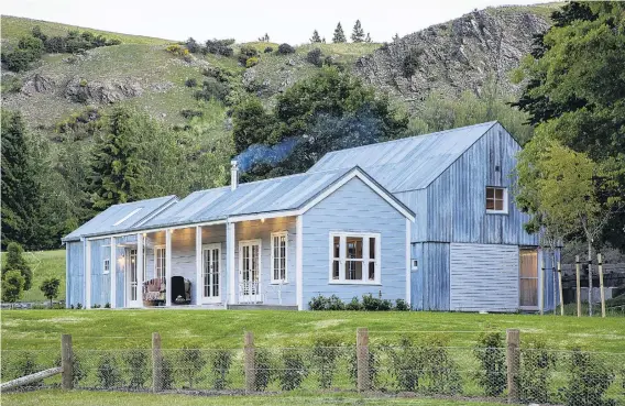  ?? PHOTOS: MARINA MATHEWS ?? A restored weatherboa­rd cottage, containing the main living areas, sits in front of a new, twostorey ‘‘barn’’ at this Lake Hayes property.