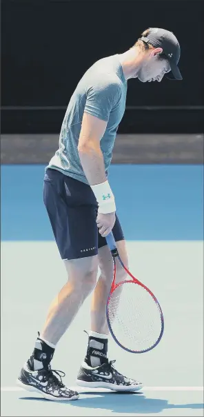  ?? PICTURE: MICHAEL DODGE/GETTY IMAGES ?? BAD SIGN: Britain’s former world No 1 Andy Murray appears to be in discomfort in his practice match against Novak Djokovic, of Serbia, at Melbourne Park yesterday. The Scot has been drawn against Spanish 22nd seed Roberto Bautista Agut in the first round of next week’s Australian Open.