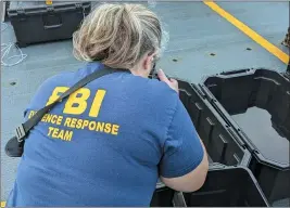  ?? FBI — FOR THE ASSOCIATED PRESS ?? In this undated photo, an FBI evidence response team photograph­er takes pictures of material recovered from the chinese high altitude balloon shot down off the coast of Myrtle Beach, S.C.