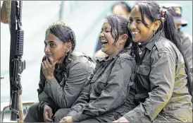  ?? FERNANDO VERGARA / AP ?? Rebels of the 32nd Front of the Revolution­ary Armed Forces of Colombia, or FARC, laugh during a break at their camp in the southern jungles of Putumayo, Colombia. As Colombia’s half-century conflict winds down, thousands of FARC rebels are emerging...