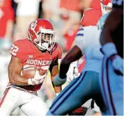  ?? [PHOTO BY BRYAN TERRY, THE OKLAHOMAN] ?? Oklahoma running back T.J. Pledger picks up yards during Saturday’s game against Kansas State on Owen Field. OU won the game, 51-14.