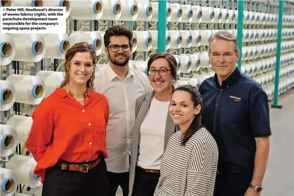  ?? ?? > Peter Hill, Heathcoat’s director of woven fabrics (right), with the parachute developmen­t team responsibl­e for the company’s ongoing space projects