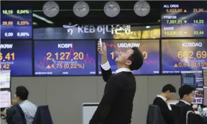  ?? Photograph: Ahn Young-joon/AP ?? Given all the deepening economic downsides, stock markets should be falling, not rising. Is this irrational exuberance?