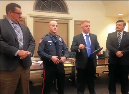  ?? ERIC DEVLIN — DIGITAL FIRST MEDIA ?? Lower Pottsgrove Board of Commission­ers Stephen Foltz and Earl E. Swavely Jr., along with Police Chief Michael Foltz award Officer Scott Burnick with a certificat­e of meritoriou­s duty for catching a dangerous felon.