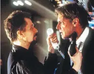  ??  ?? Gary Oldman, left, portraying a Russian terrorist hijacker, holds a gun to Harrison Ford, who portrays the U.S. president in 1997’s “Air Force One.”