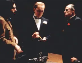  ??  ?? Above from left: The
Godfather director Francis Ford Coppola, Robert Duvall, Marlon Brando on set in 1972