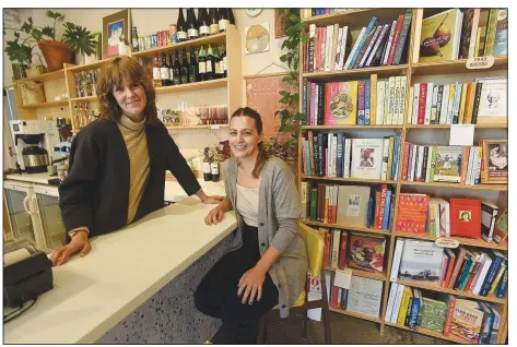  ?? (NWA Democrat-Gazette/Flip Putthoff) ?? Rachel Stuckey-Slaton (left) and Monica Diodati, owners of Two Friends Books, pause for a photo at their biggest and newest store location at the 8th Street Market in Bentonvill­e.