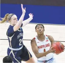  ?? ERIC GAY/AP ?? Maryland guard Diamond Miller drives to the basket past Mount St. Mary’s guard Kayla Agentowicz during the first half of an NCAA tournament firstround game Monday at the Alamodome in San Antonio.