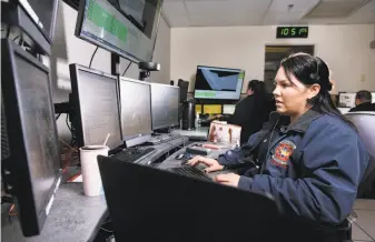  ?? Michael Short / Special to The Chronicle 2017 ?? Jennifer Chavarria takes a 911 call at the Alameda County Fire Department dispatch center in Livermore. Workers across California are racing to adopt a cohesive emergency alert system.