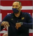  ?? MORRY GASH — THE ASSOCIATED PRESS ?? Michigan coach Juwan Howard reacts during Sunday’s win over Wisconsin. The Wolverines stayed at No. 3in the latest AP Top 25.