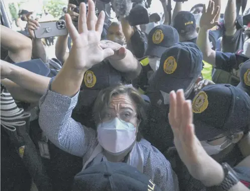  ?? ?? ↑ Former Philippine senator and human rights campaigner Leila de Lima waves as she arrives to attend her hearing at court