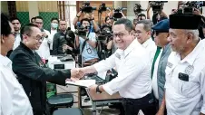  ?? — AFP photo ?? Members of the legal team of Anies file a petition over the February 2024 elections at the Constituti­onal Court in Jakarta.