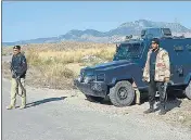  ?? AFP ?? Policemen guard a road near the burnt Hindu temple.